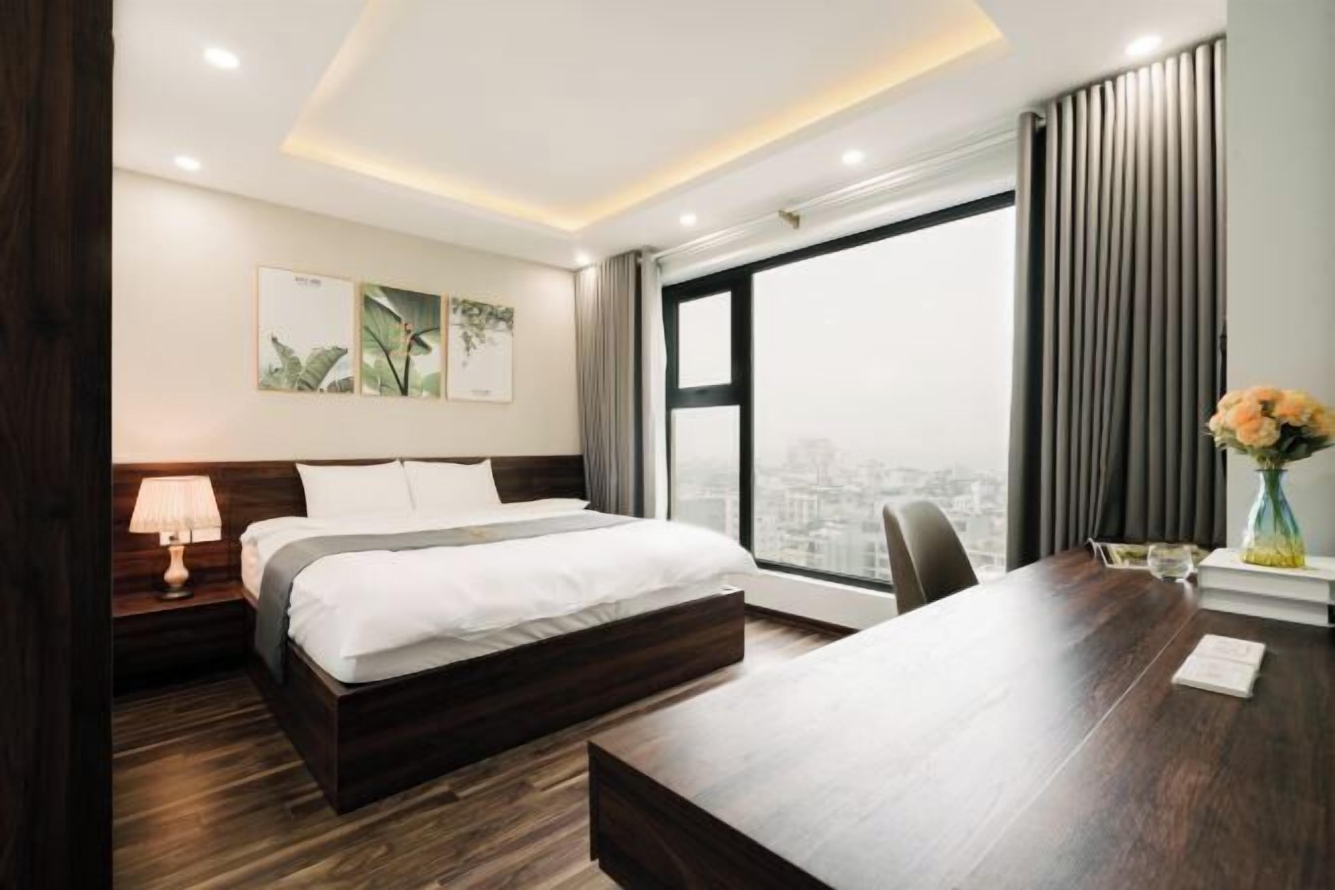 Premium bedding, desk, laptop workspace, blackout drapes