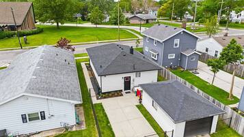 A residential area with houses, a driveway, and a lawn.