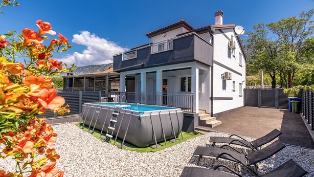 A two-story house with a swimming pool, a covered patio, and a fenced garden area. - Pool House Beba Tribalj Lake (Vinodol)