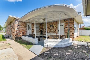 A covered patio area with outdoor furniture, a brick exterior, and a clear sky. - ~ 1 Mi to the Strand: Central Unit in Galveston! (Galveston)