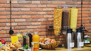 A breakfast buffet with various food items and beverages, including cereals, fruits, and hot beverages. - Atrium Boutique Hotel (Tbilisi)