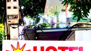 A sign for a hotel named "HOTEL HOLIDAY" with a date and location information. - Holiday Hotel 2 (Hai Phong)