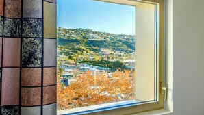 A window with a view of a town, buildings, and trees. - B&B HOTEL Nice Stade Riviera (Nice)