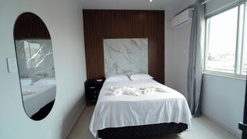 Desk, laptop workspace, iron/ironing board, bed sheets
