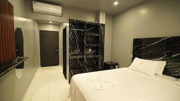 Deluxe Triple Room | Desk, laptop workspace, iron/ironing board, bed sheets