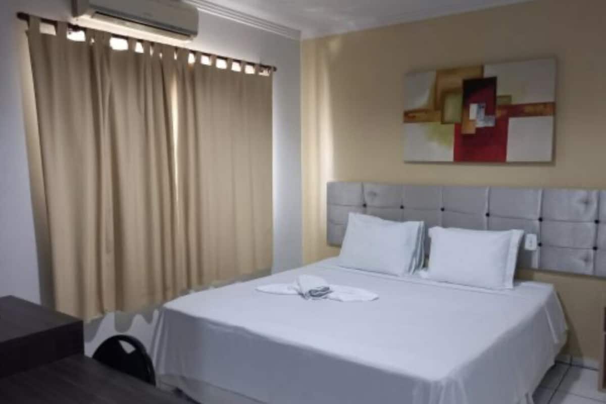Desk, laptop workspace, iron/ironing board, bed sheets
