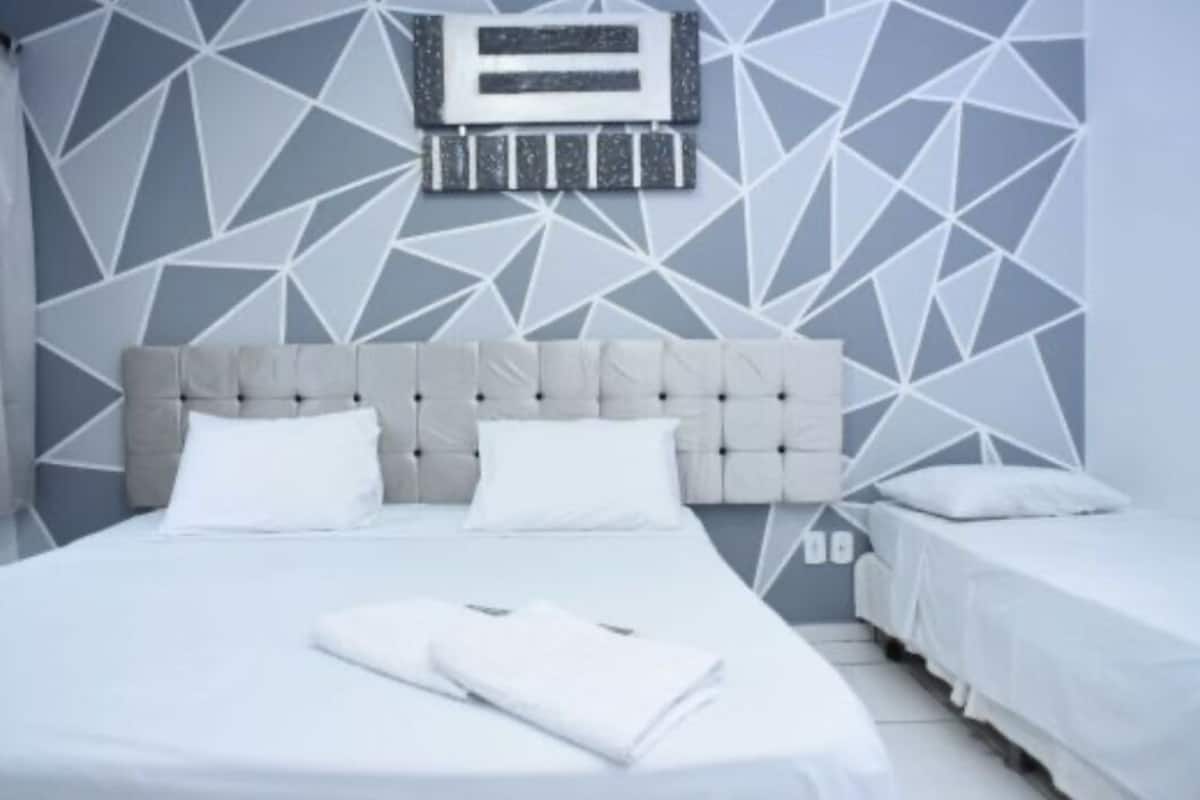 Desk, laptop workspace, iron/ironing board, bed sheets