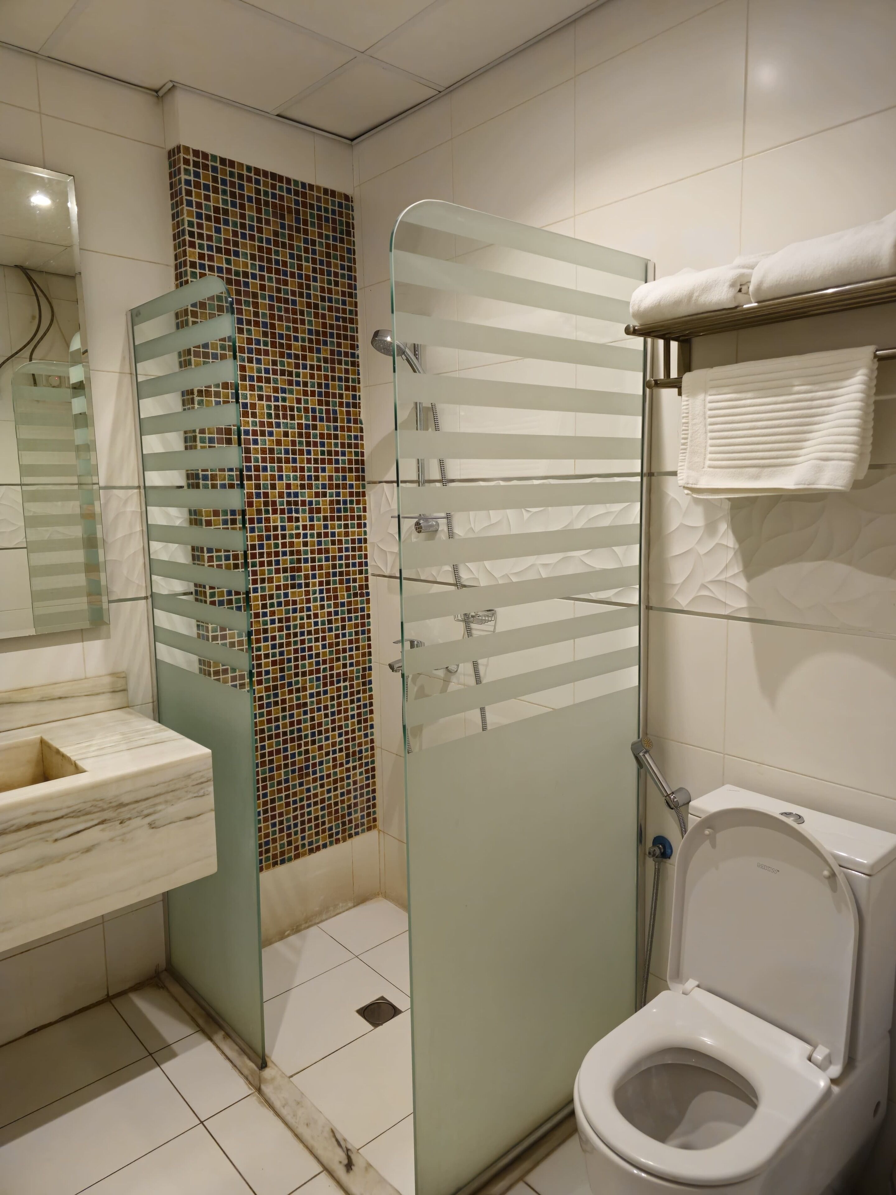 junior suite, 1 king bed | bathroom | separate bathtub and shower, rainfall showerhead, hair dryer, slippers