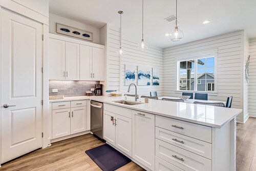 Three-story townhouse with a balcony, two living areas, & a washer/dryer