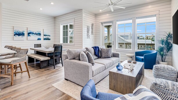 A modern living room with a sofa, coffee table, and seating area. - Three-story townhouse with a balcony, two living areas, & a washer/dryer (Port Aransas)