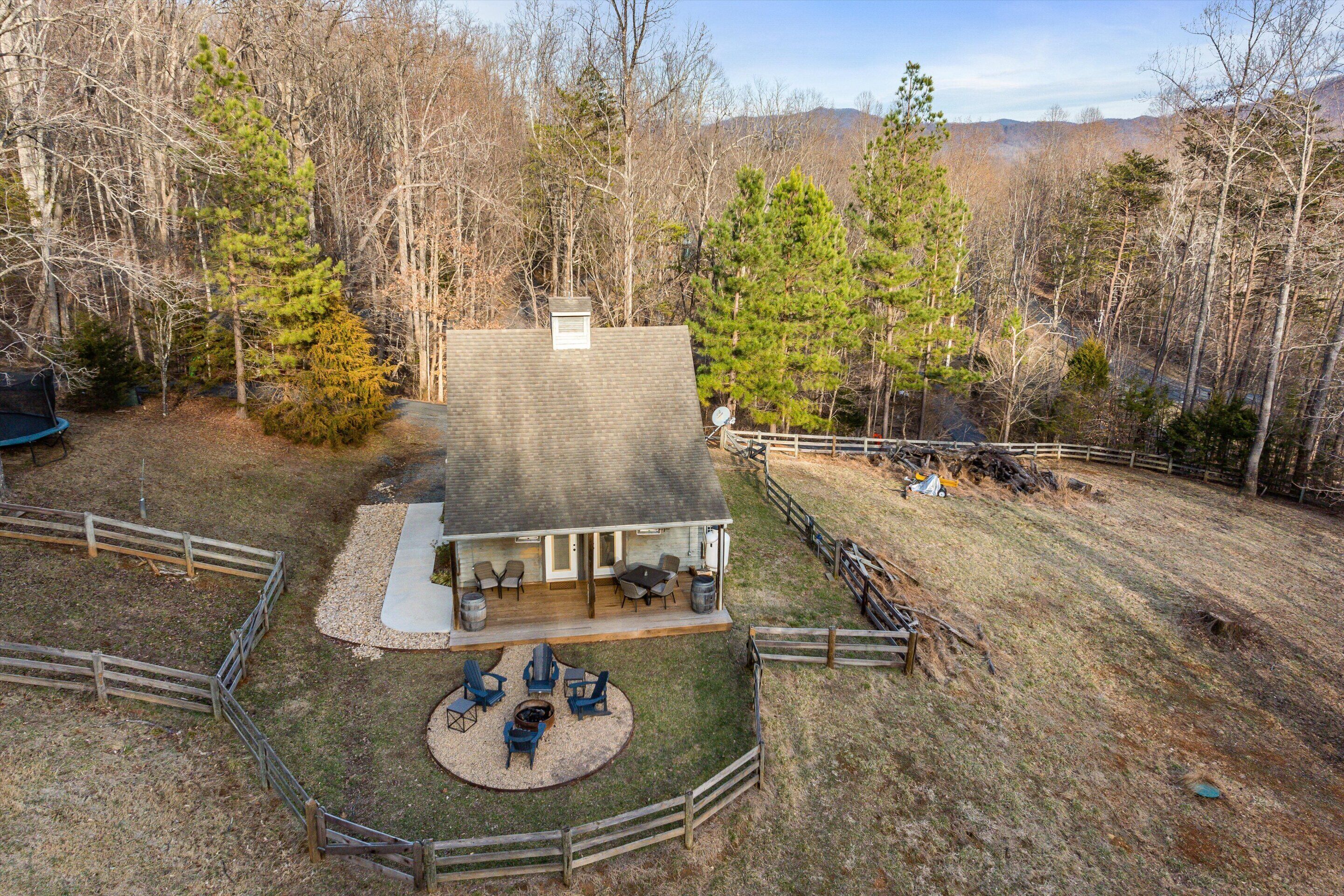 A house with a patio area, outdoor seating, and a fire pit.