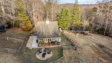 A house with a patio area, outdoor seating, and a fire pit.