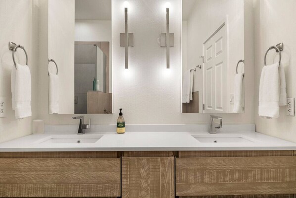 A modern bathroom with two sinks, a large mirror, and a bottle of hand soap. - Lakefront Condo w/ Heated Pool + spa in Scottsdale (Scottsdale)