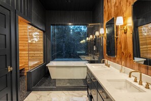 Bathtub, hair dryer, towels, toilet paper