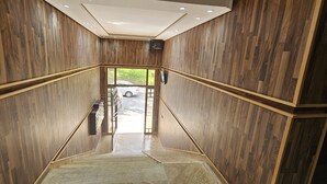 A wooden interior with a staircase leading to an outdoor area. - Les Belles Residences F (Tangier)