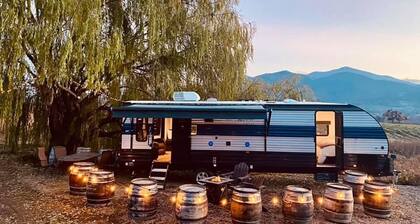 Cherokee RV features a queen-sized bed, dining area, and full kitchen.