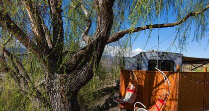 Cherokee RV features a queen-sized bed, dining area, and full kitchen.
