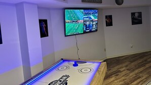 A room with a flat-screen TV mounted on the wall, a pool table, and sports-themed decorations. - Breathtaking mountain views-4king en suites, bunk rm, sauna, air hockey,MANCAVE! (Hot Springs Village)