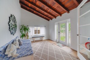 Deluxe House | Living area | 50-inch Smart TV with satellite channels