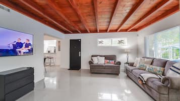 Deluxe House | Living area | 50-inch Smart TV with satellite channels