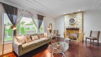 Deluxe House | Living area | 50-inch Smart TV with satellite channels