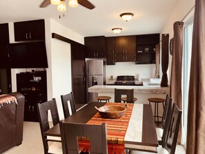 Enjoy meals at the dining table with comfortable seating for family gatherings or entertaining guests.