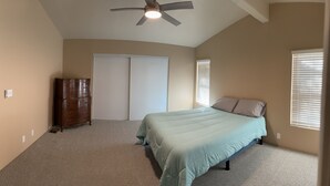 A bedroom with a bed, a ceiling fan, a wardrobe, and a closet. - Enjoy living on a pecan orchard surrounded by trees!!!!!!
 (Las Cruces)