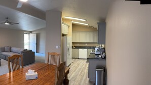 A modern kitchen with white cabinets, a stainless steel refrigerator, and a coffee machine. - Enjoy living on a pecan orchard surrounded by trees!!!!!!
 (Las Cruces)
