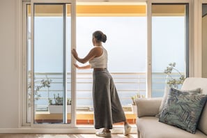 Relax on the balcony with a view of the sea, surrounded by a clean and minimalist design.