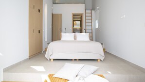 A modern bedroom with a large bed, wooden wardrobe, and a ladder leading to a loft. - Sea View Villa Selina with private sea access and infinity pool (Sivota Lefkada)