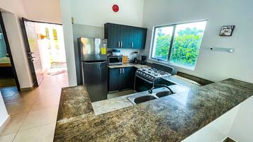 Fridge, microwave, coffee/tea maker, cookware/dishes/utensils