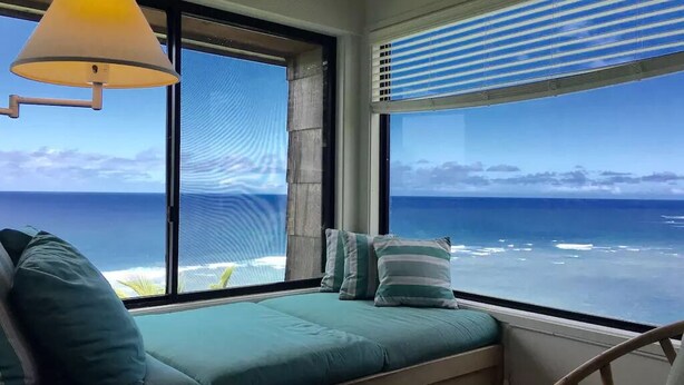 A room with a view of the ocean, a bed with green bedding, a lamp, and a chair. - Sealodge J7 - 2BR/2BA, 2nd Floor Prime End Unit, Spectacular Oceanfront Views (Princeville)
