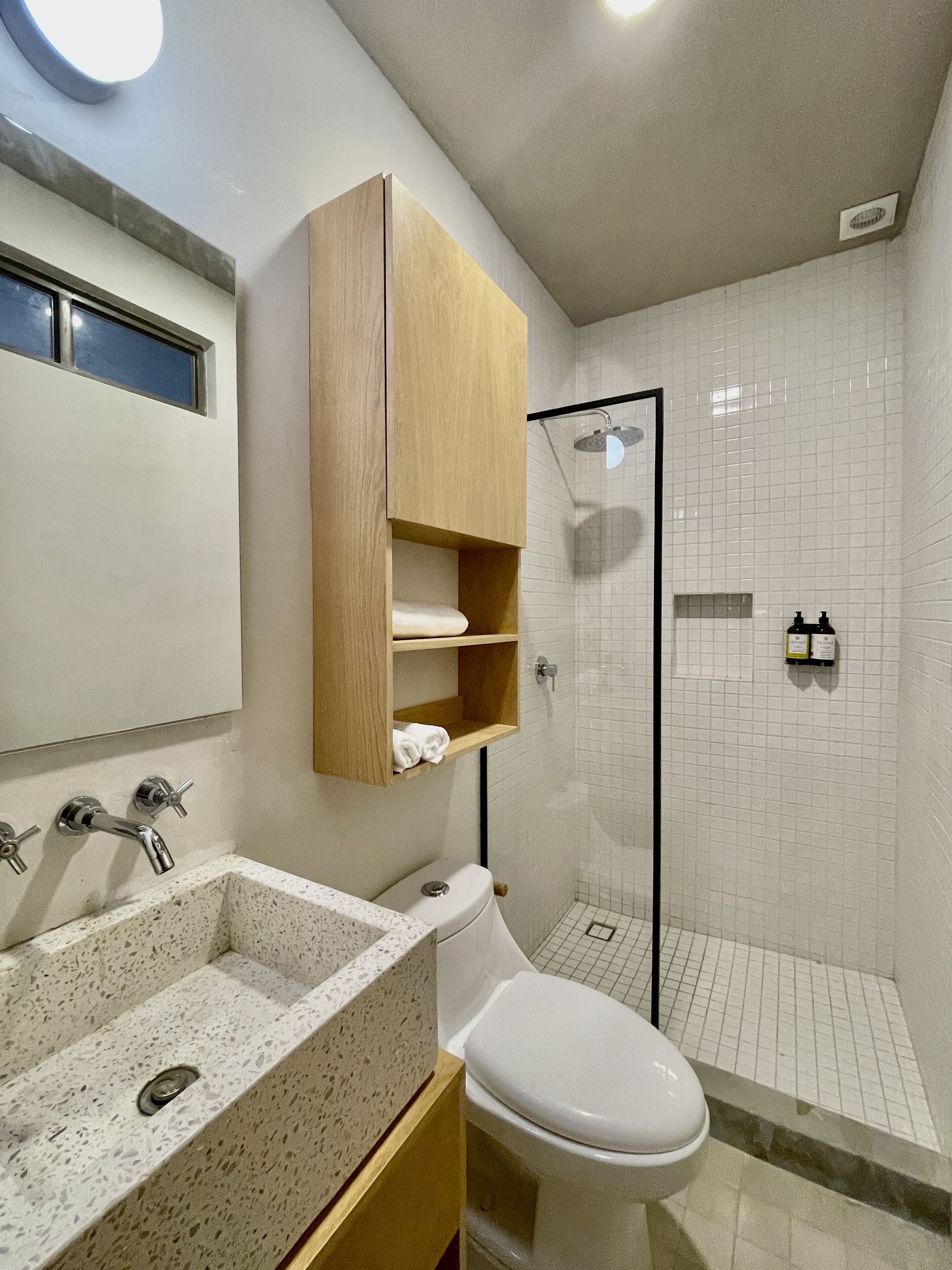 A bathroom with a sink, toilet, and shower.