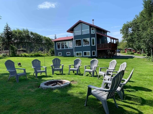 A house with a fire pit and outdoor seating.