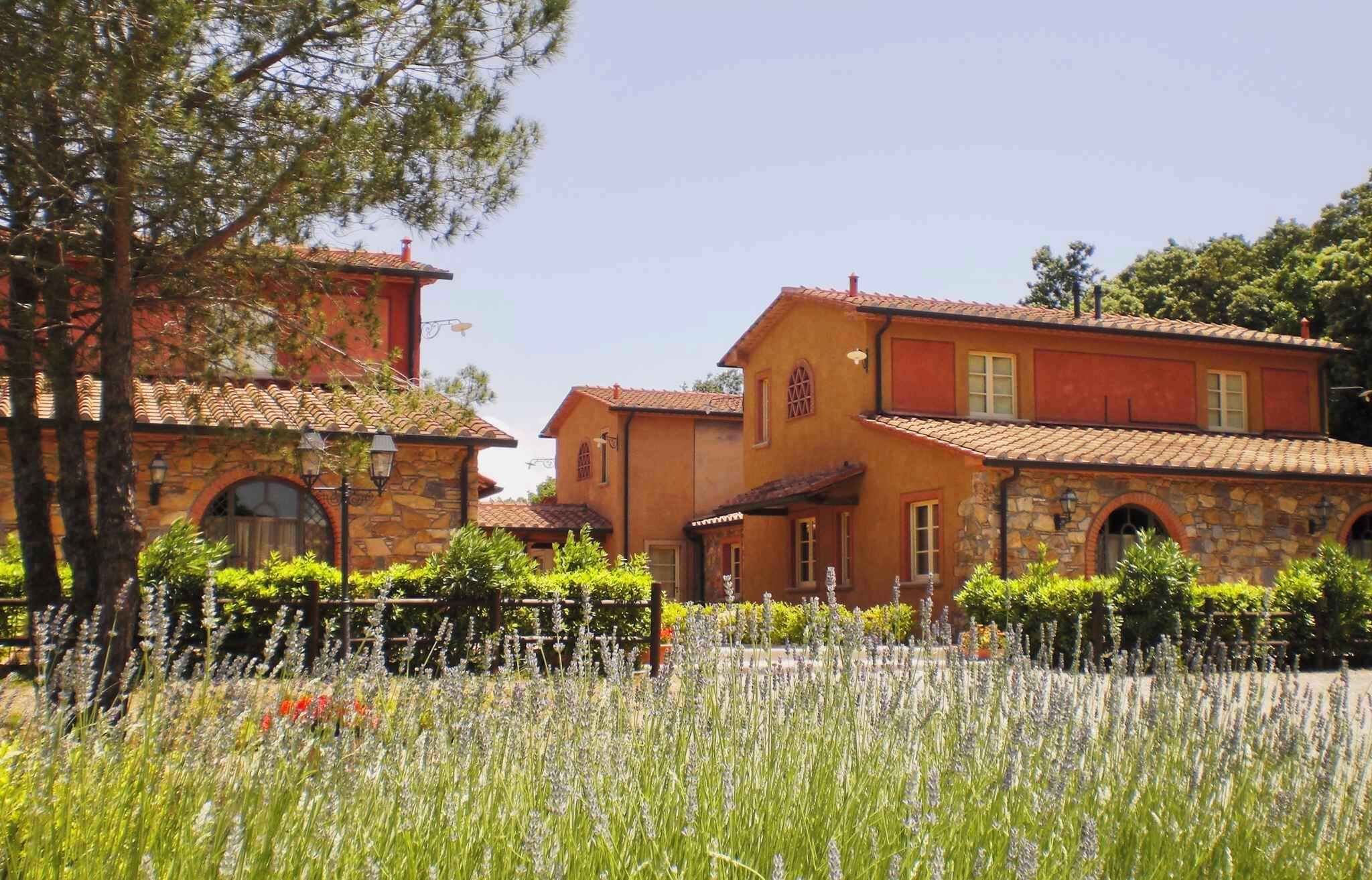 A traditional Mediterranean-style building with stone and stucco exteriors, arched windows, and a tiled roof.