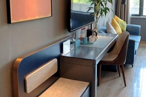 A modern hotel room with a sofa, a dining table, a TV, and a plant. - LANOU Hotel (Lanling Agricultural Park) (Lanling)