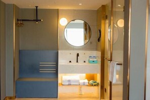 A modern bathroom with a shower, a sink with a mirror, and a towel rack. - LANOU Hotel (Lanling Agricultural Park) (Lanling)