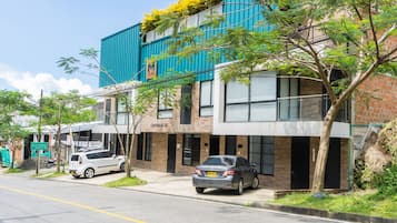 Urban streets come alive with a mix of historic and modern architecture, lined with lush greenery and vibrant city life.