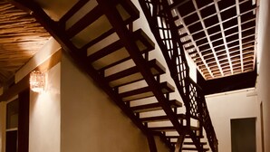A staircase with a wooden railing leading to a landing. - Casa Cielito Lindo Cozumel (Cozumel)