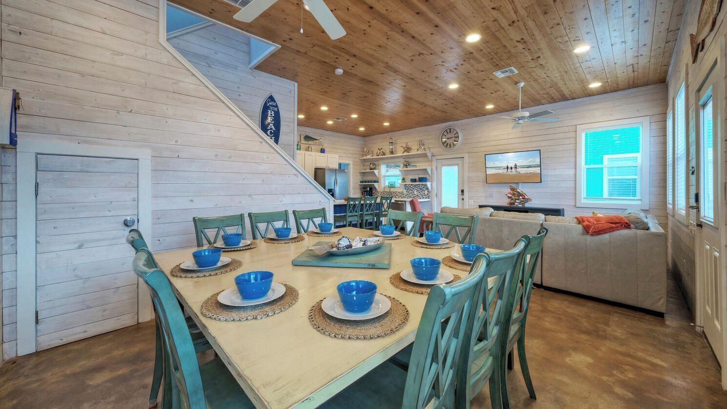 A wooden interior with a dining area, kitchen, and living space.