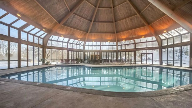 An indoor swimming pool with a wooden ceiling and large windows. - Camelback - Game Room, Near Hiking & Waterparks (Tannersville)