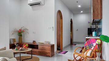 A modern living room with a sofa, a wooden coffee table, and a decorative vase.