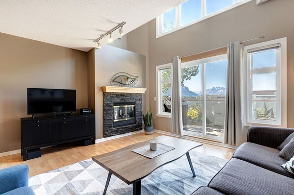 TV, fireplace, stereo - Cozy Condo | Epic Mountain Views | Parking Garage | Central | Air Conditioning (Canmore)