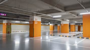 A multi-level parking garage with clearly marked parking bays and directional signs.