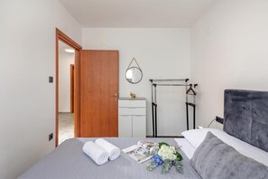 A hotel room with a bed, a wardrobe, a mirror, and a radiator. - Pool House Beba Tribalj Lake, Tribalj, Croatia (Tribalj)