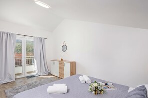 A bedroom with a bed, a bedside table with a mirror, a dresser, and a view of a balcony with curtains. - Pool House Beba Tribalj Lake, Tribalj, Croatia (Tribalj)