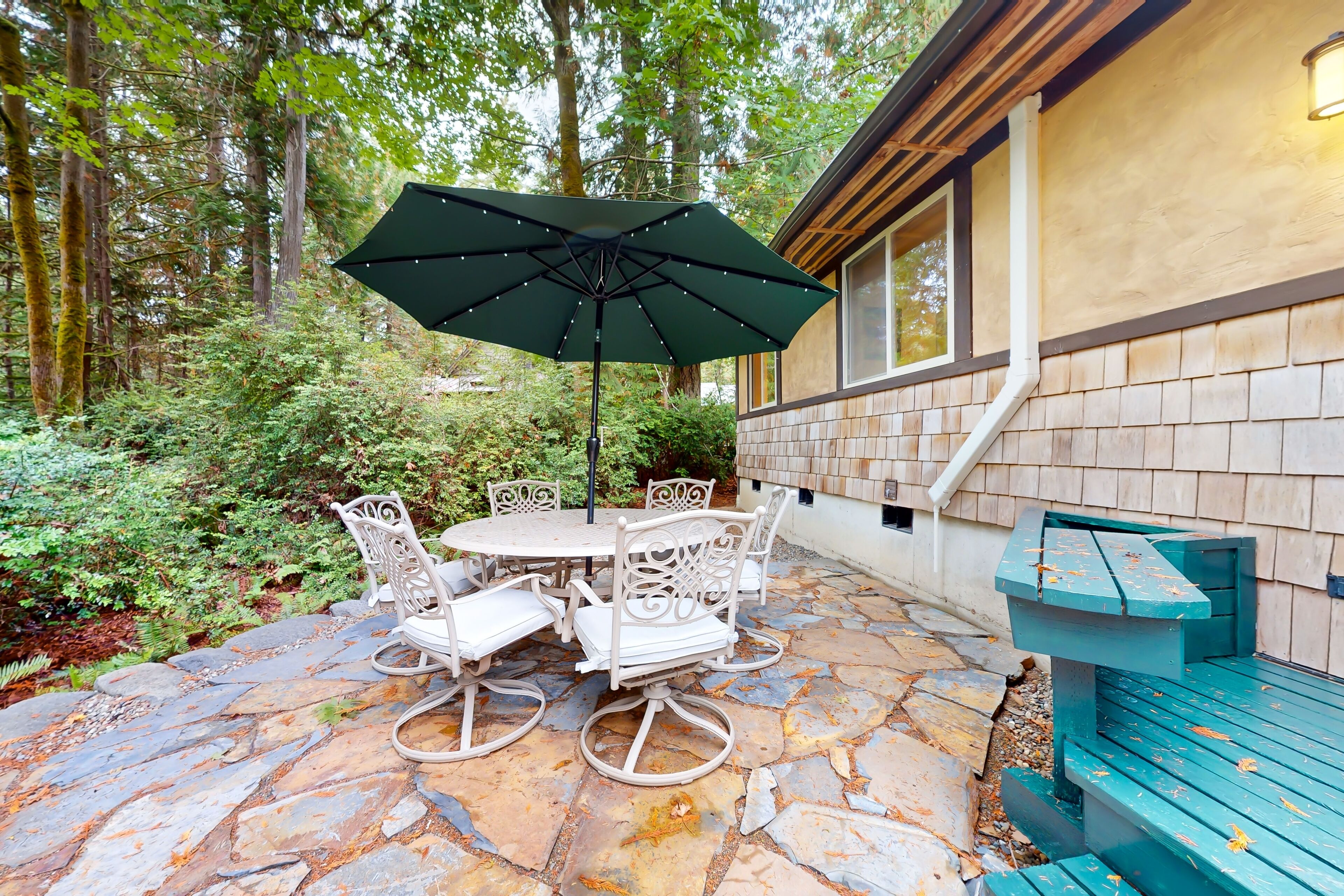 Tree-lined retreat with wood fireplace, board game collection, & pool access