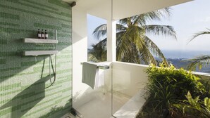 A modern bathroom with a green mosaic wall, a glass shower enclosure, and a view of palm trees and the ocean. - Splash 4 Bed :Contemporary Tropical Five Star Villa (Koh Samui)