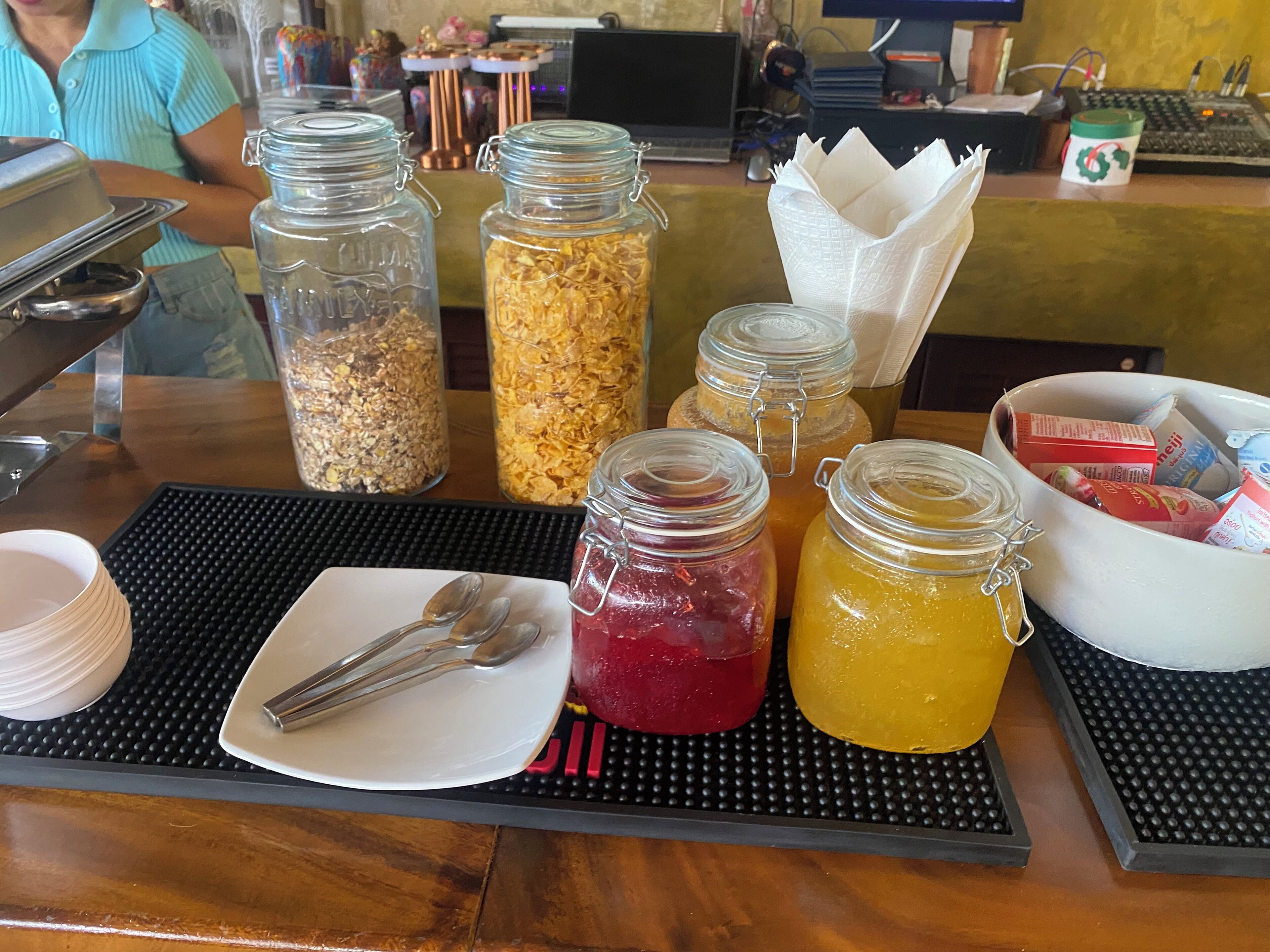 A breakfast bar with various food items and condiments.
