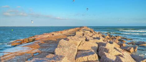 A rocky shoreline with waves crashing against the rocks.